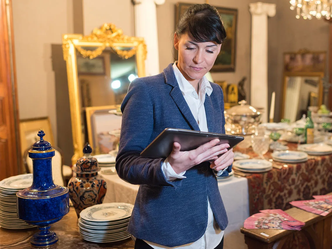 Careful hands appraising antique china
